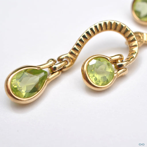 Waterfall Dangle Navel Curve in Yellow Gold with Peridot from BVLA with peridot close up