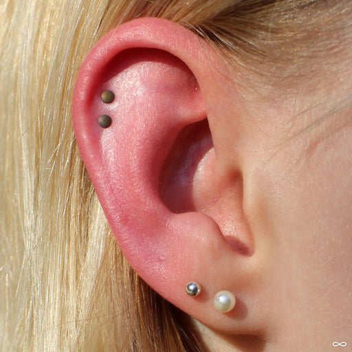 Textured Disk Press-fit End in Titanium from NeoMetal in two outer helix piercings