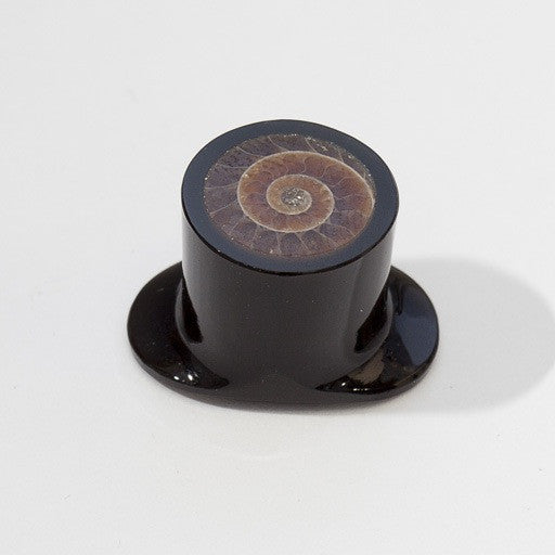 Large labret made with obsidian featuring a cut sliver of ammonite in the center