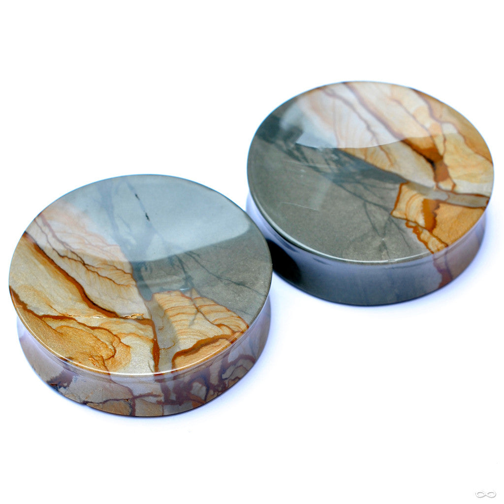 Pair of stone plugs from Stone Witch featuring organic orange and blue hued patterns