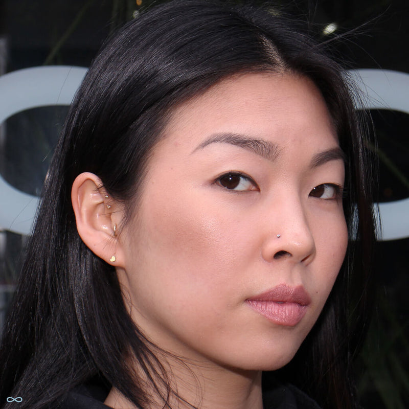 Double forward helix piercings by Kellan