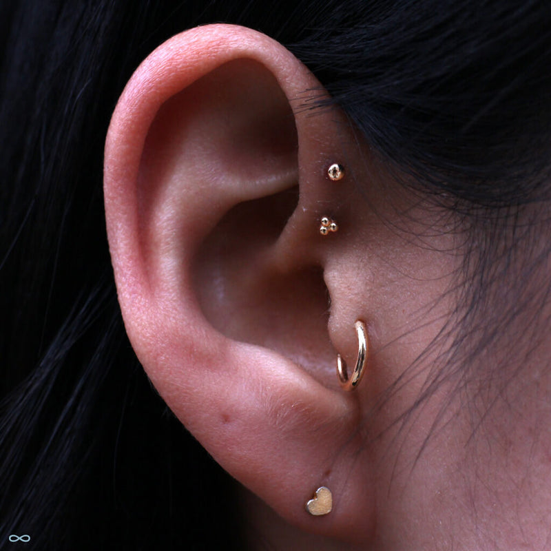 Double forward helix piercings by Kellan