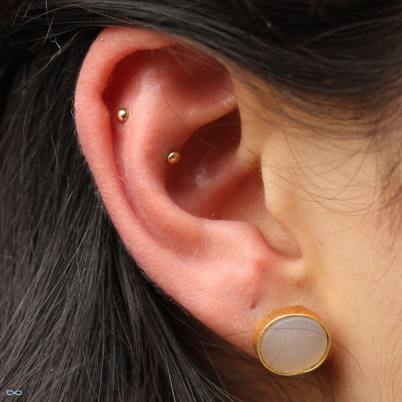 Outer helix and conch piercings by Andru