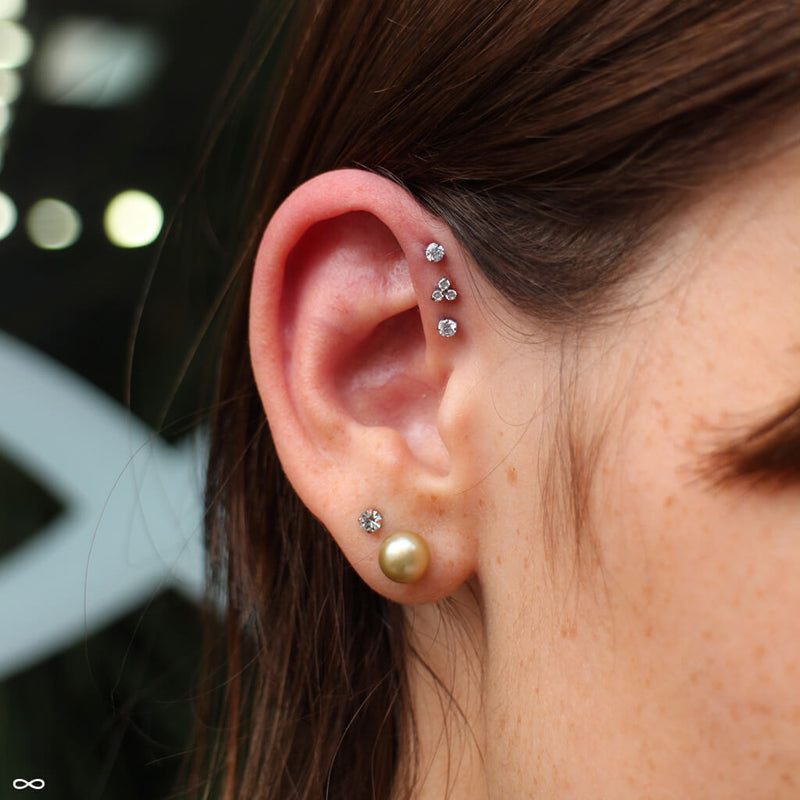 Triple forward helix piercings by John