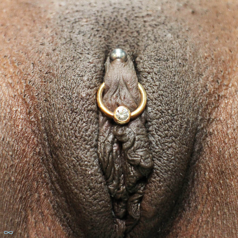 Vertical and horizontal clitoral hood piercings by Kellan