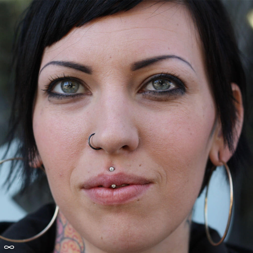 Vertical philtrum piercing by Andru