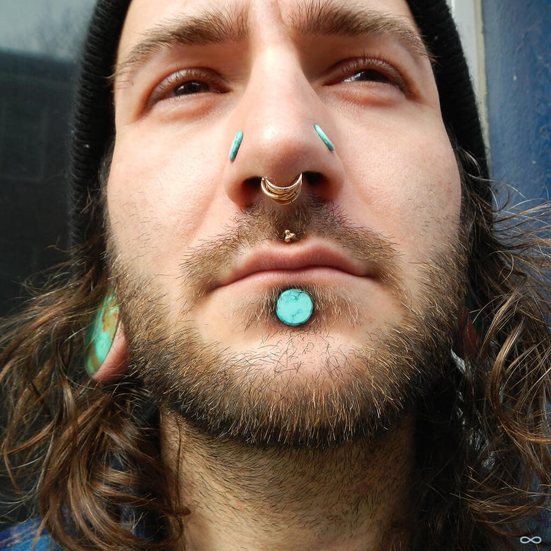 Stretched earlobe, nostril and labret piercings