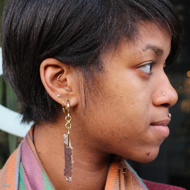 Stretched earlobe piercings with weights