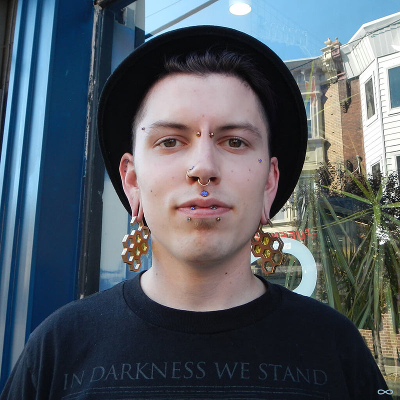 Stretched earlobe piercings with weights
