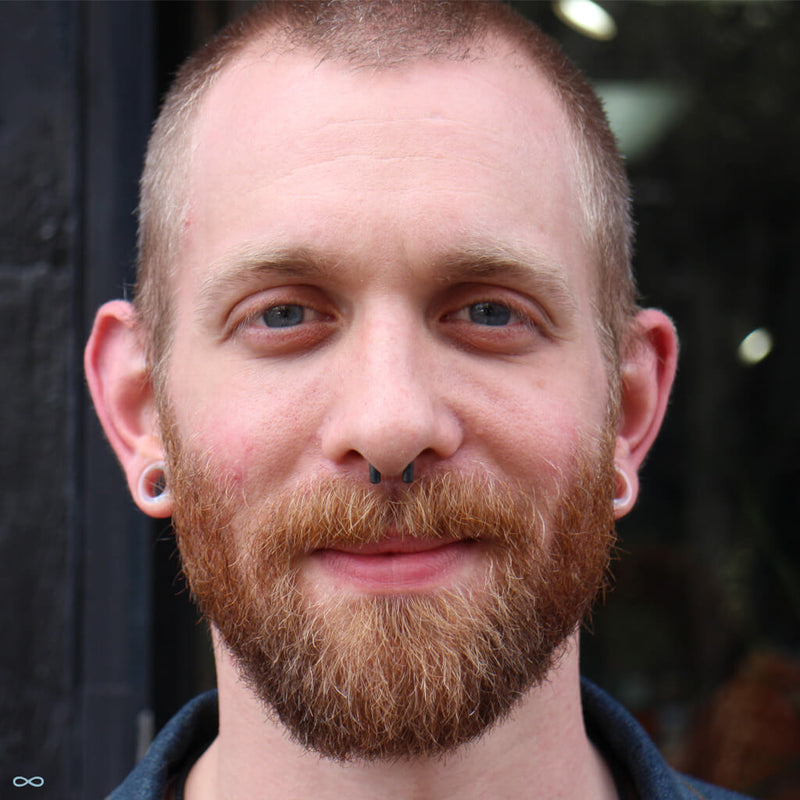 Stretched earlobe and septum piercings