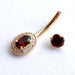 Oval Halo Curved Barbell in Gold with Garnet & Clear CZ from BVLA