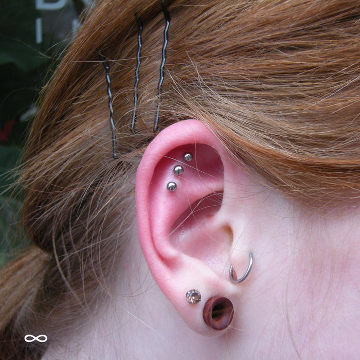 Three Outer Helix piercings with Ball Press-fit End in Titanium from NeoMetal in 1/8"