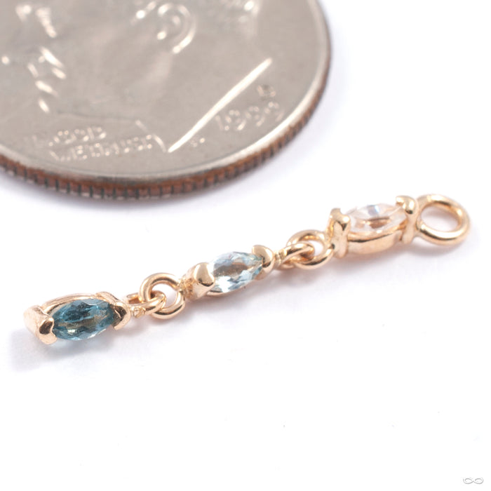 Adore Charm in Gold from Quetzalli in yellow gold with white sappire sky blue topaz and london blue topaz