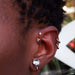 Forward helix piercing (upper) with Prong-set Gemstone Press-fit End in Titanium from NeoMetal in Champagne CZ