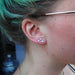 Triple earlobe piercing with Bezel-set Cabochon Press-fit End in Titanium from NeoMetal in White Coral