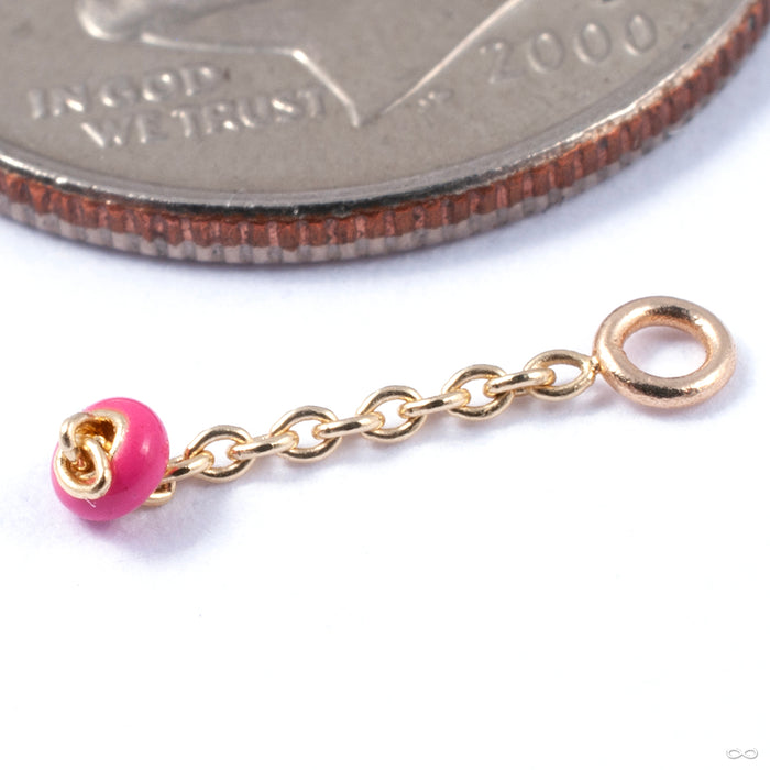 Vibrant Charm in Gold from Pupil Hall in yellow gold with hot pink enamel