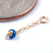 Vibrant Charm in Gold from Pupil Hall in yellow gold with true blue enamel