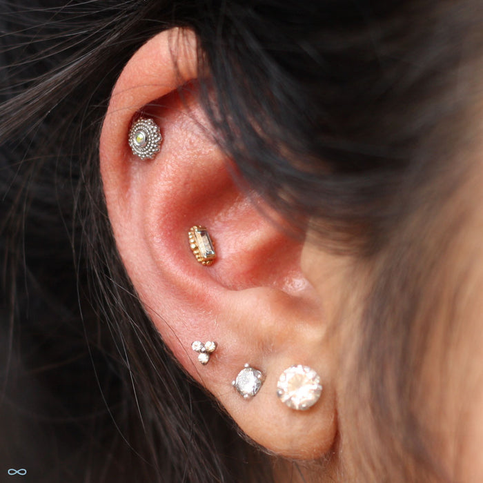 Conch piercing with Beaded Baguette Press-fit End in Gold from BVLA with Chatham Alexandrite