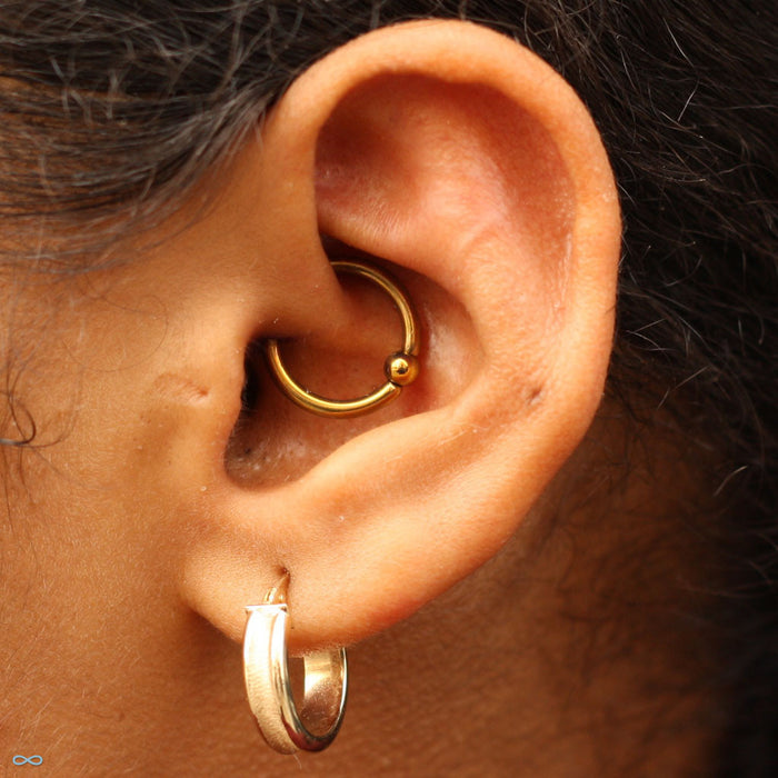 Daith piercing with Captive Bead Ring in Niobium from SM 316