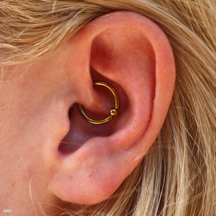 Daith piercing with Captive Bead Ring in Niobium from SM 316
