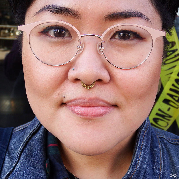 Septum piercing with Melange Clicker from Tether Jewelry in Yellow Gold