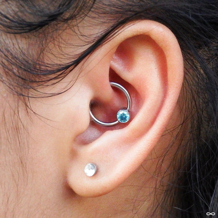 Daith piercing with Captive Gem Bead in Titanium from Industrial Strength in Mint CZ