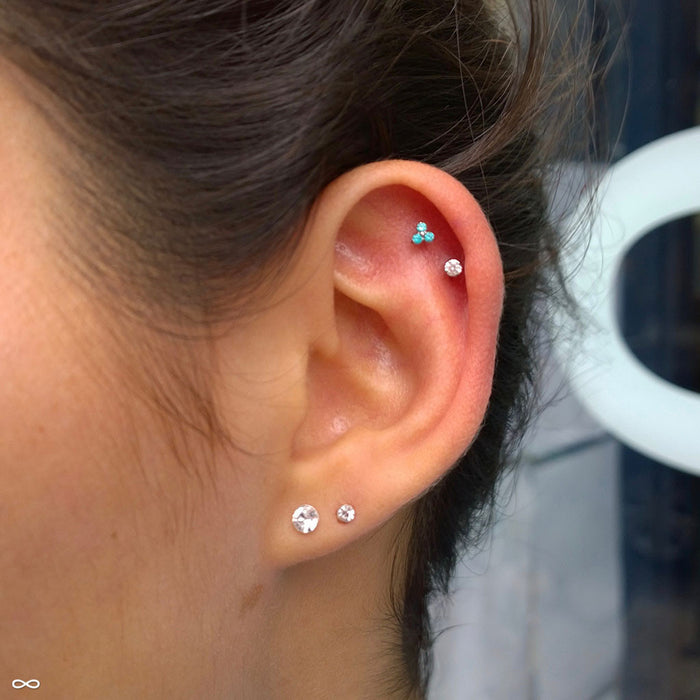Outer helix piercing with Trinity Press-fit End in Titanium from NeoMetal in Mint CZ