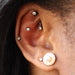 Outer helix piercing with Bezel-set Gemstone Press-fit End in Titanium from NeoMetal in 2.5mm Clear CZ