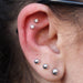 Two outer helix piercings with Bezel-set Gemstone Press-fit End in Titanium from NeoMetal in 2.5mm Clear CZ