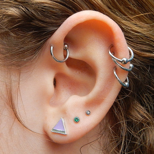 Forward helix and three outer helix piercings with Daith piercing with Captive Bead Ring from SM 316