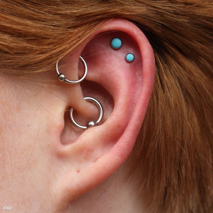 Two outer helix piercings with Bezel-set Cabochon Press-fit Ends in Titanium from NeoMetal with 4mm & 3mm turquoise