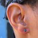 Earlobe piercing with Prong-set Gemstone Press-fit End in Titanium from NeoMetal in 4mm Black CZ