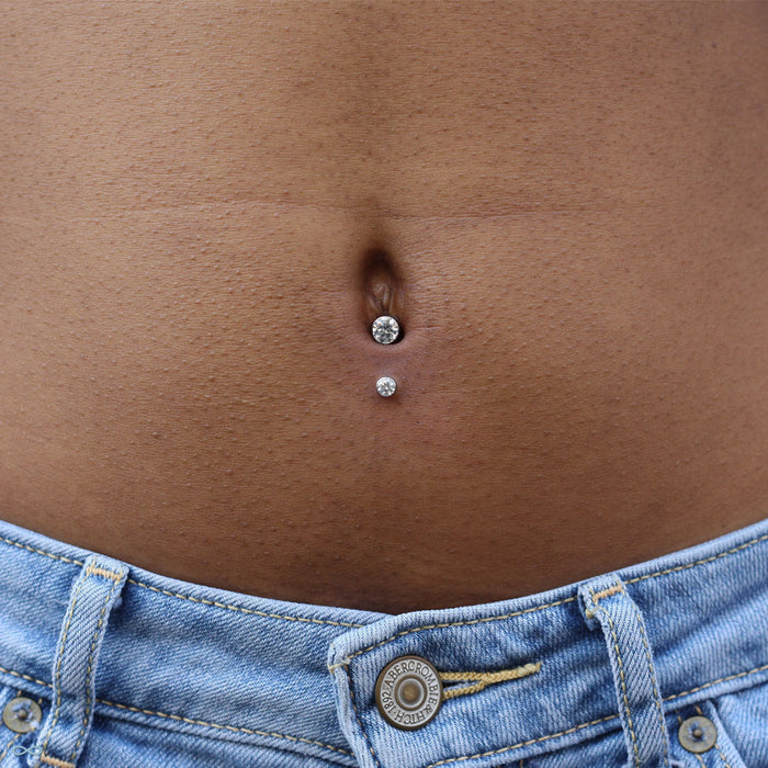 Navel piercing with Bezel-set Gem Curved Barbell from Industrial Strength with Clear CZ