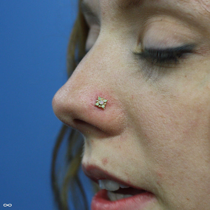 Nostril piercing with Orion Press-fit End in Gold from BVLA in White Opal & Tsavorite