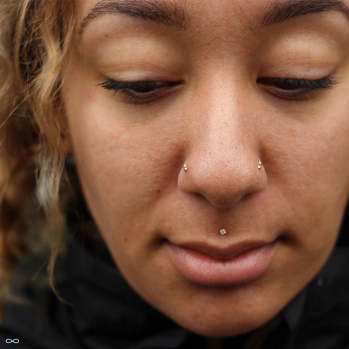 Four nostril piercings with Dome Press-fit End in Gold from LeRoi in 2mm & 2.5mm 14k Yellow Gold