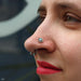 Nostril piercing with Vice Press-fit End in Gold from Anatometal in Light Blue Opal