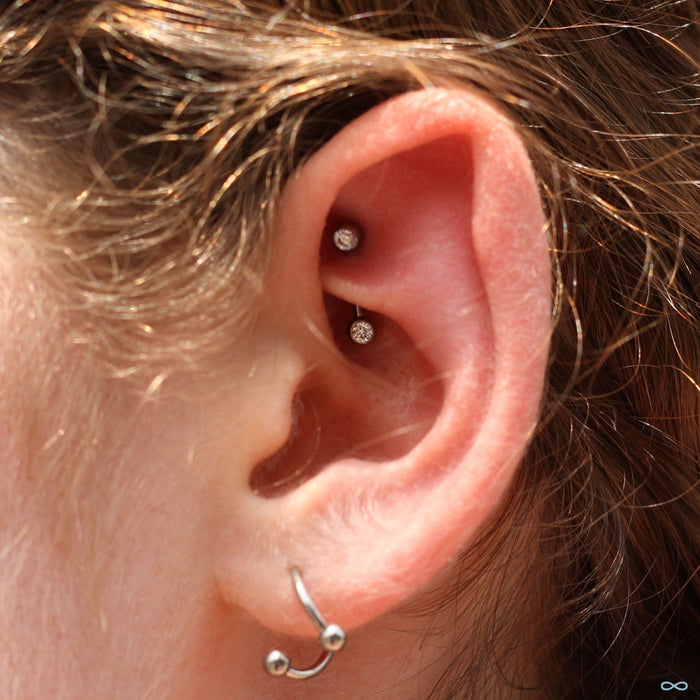 Rook piercing with Curved Press-fit Post with Side-set CZs in Titanium from NeoMetal with Clear CZ