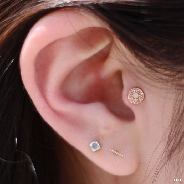Tragus piercing with Elizabeth Press-fit End in Gold from BVLA in White Opal