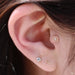 Tragus piercing with Elizabeth Press-fit End in Gold from BVLA in White Opal