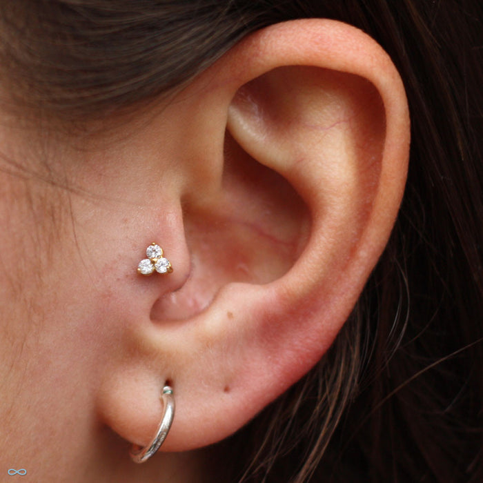 Tragus piercing with Trinity Press-fit End in Gold from LeRoi in Clear CZ